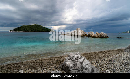 Dramatic Sky and rocky beach before a storm over the  Skopelos island in Greece. Stock Photo