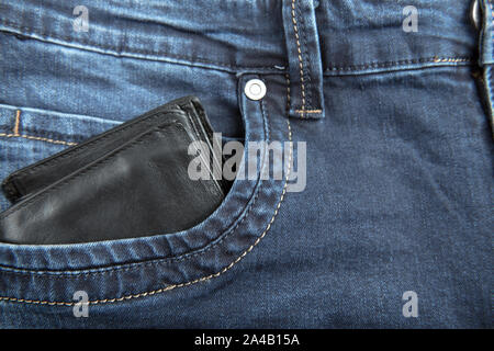 Black leather male wallet in jeans pocket with copy space for text Stock Photo