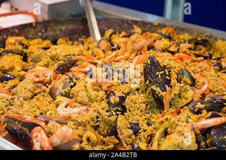 Freshly made shellfish paella at a market stall in France Stock Photo