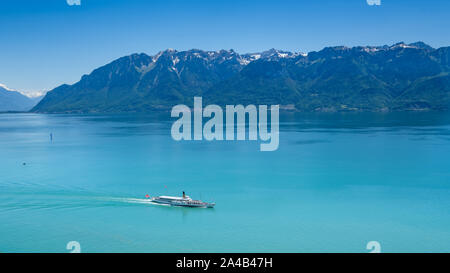 A vintage paddle wheel boat cruises from Montreux on Lake Geneva Stock Photo