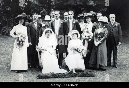 Archival photograph of a wedding party outdoors circa 1913 showing 16 people. Stock Photo