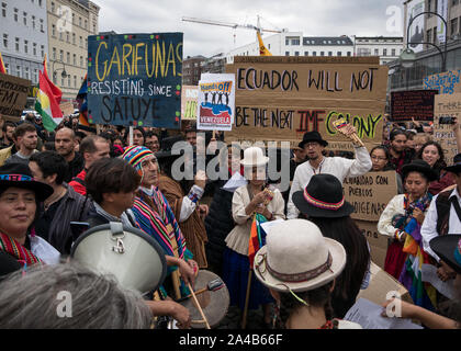 Demostration and protest against President Moreno's politics in Ecuador, crowd of people in traditional clothes showing banners while playing music Stock Photo