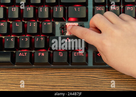 child hand clicks on broken enter Stock Photo