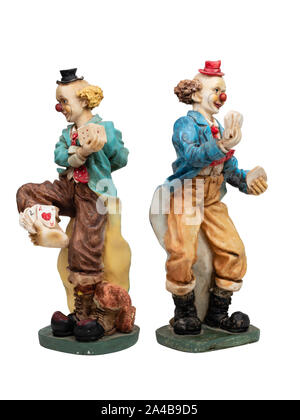 Pair of painted resin playing card and dice juggling clown figurines on a white background Stock Photo
