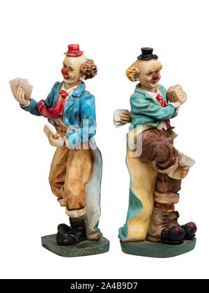 Pair of painted resin playing card and dice juggling clown figurines on a white background Stock Photo