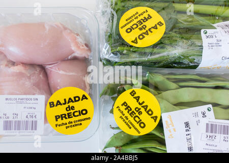 Vegetables and chicken thighs packed in plastic packaging with reduced price sticker in supermarket in Spain. Stock Photo