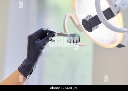 Close-up dental x-ray shot of teeth in the hands of dentist doctor at clinic Stock Photo