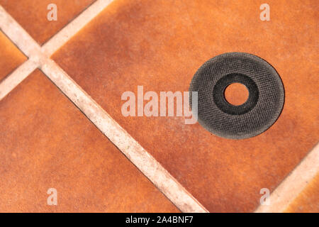 Cutting disc of a radial prepared for installation and shown on clay soil in the inner courtyard Stock Photo