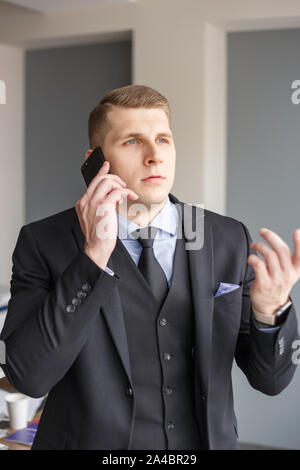 Businessman disputing on the phone Stock Photo