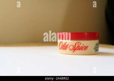 1960s glass jar of Old Spice brilliantine with a tin red top; classic grooming hair care products for men. Stock Photo