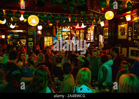 People taking and enjoying drinks at the Temple Bar, famous pub in Dublin, Ireland Stock Photo