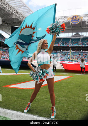 A Washington Redskins cheerleader performs in a Santa Claus