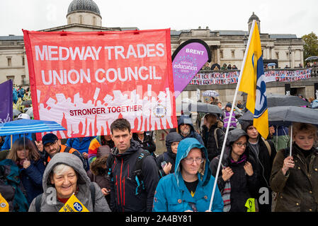Trafalgar Square, London, UK. 12th October 2019. Extinction Rebellion asked Trade Unions to join their rebellion in Trafalgar Square. A Trade Union presence was active with speakers, and they later joined an XR march. Speakers, TU and XR supporters braved continuous rain. Credit: Stephen Bell/Alamy Stock Photo