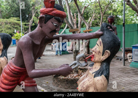 Bang Saen, Thailand - March 16, 2019: Garden of Hell in Wang Saensuk Buddhist Monastery. Scene wherein devil pulls tongue of female liar. Stock Photo