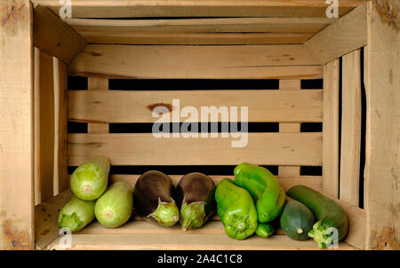 Old wooden fruit box with freshly picked fresh vegetables Stock Photo