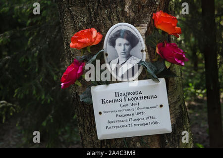 Photograph of one of the victims of Bolshevik political repressions installed by her relatives at the Levashovo Memorial Cemetery in the forest next to Levashovo railway station near Saint Petersburg, Russia. The forest became the mass burial place of the people executed during the Great Purge by the Soviet secret police NKVD, later known as the KGB. There were at least 19,000 victims of political repressions buried here from 1937 to 1954. According to other sources, about 45,000 people could be buried at at the Levashovo Memorial Cemetery in unmarked graves. Stock Photo