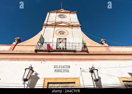 The town hall and government offices housed in an old colonial style building in Mineral de Pozos, Guanajuato, Mexico. The town, once a major silver mining center was abandoned and left to ruin but has slowly comeback to life as a bohemian arts community. Stock Photo