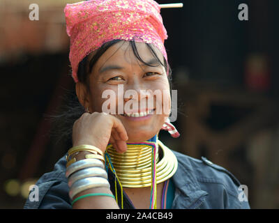 Myanmarese Kayan Lahwi woman (“giraffe woman”) with tribal brass neck rings/coils smiles for the camera. Stock Photo