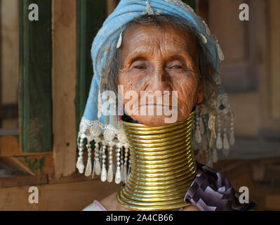 Very old Myanmarese Kayan Lahwi woman (“giraffe woman”) with 20 tribal brass neck rings/coils poses for the camera.