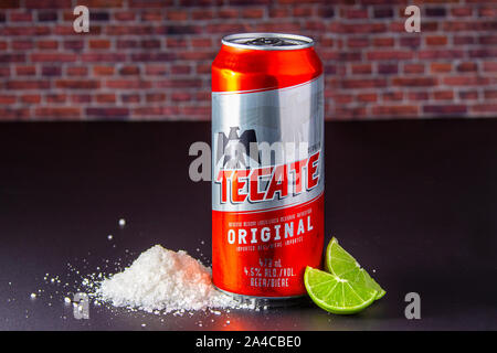 Tecate beer can with salt and limes on the side. Stock Photo