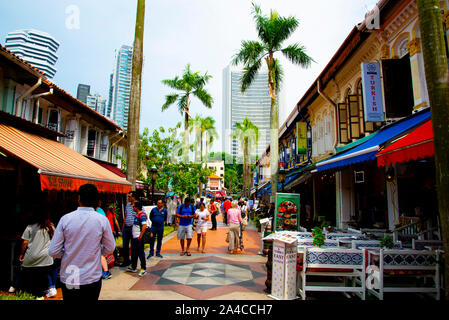 SINGAPORE CITY, SINGAPORE - April 12, 2019: Tourists & shops on Muscat Street opposite the Sultan Mosque Stock Photo