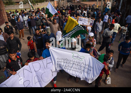 Srinagar, India. 11th Oct, 2019. Kashmiri protesters hold banners and flags during the demonstration.After Friday prayers hundreds of people took part in a demonstration in the Soura neighborhood. Tensions have been escalating since the Indian government removed the region's partial autonomy three weeks ago. Information has also been scarce, as internet and mobile networks have been blocked. Credit: SOPA Images Limited/Alamy Live News Stock Photo