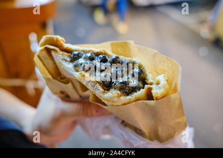 Bubble tea toast (Boba toast) at Ruifeng night market. It's a butter-toasted bread filled with brown sugar, milk foam and tapioca pearls. Stock Photo