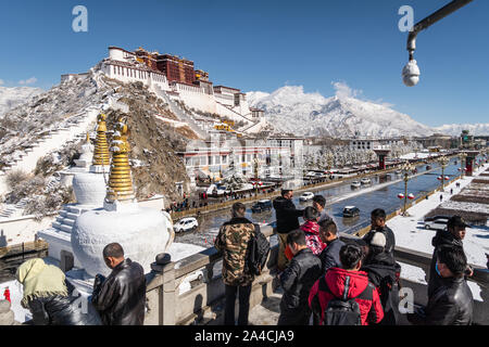 Lhasa, China - December 26 2018: Chinese tourist enjoy the view of the famous Potala Palace from the viewpoint in Lhasa in Tibet province on a sunny w Stock Photo