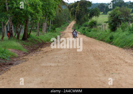 A motorcycle rider carrying passengers Stock Photo