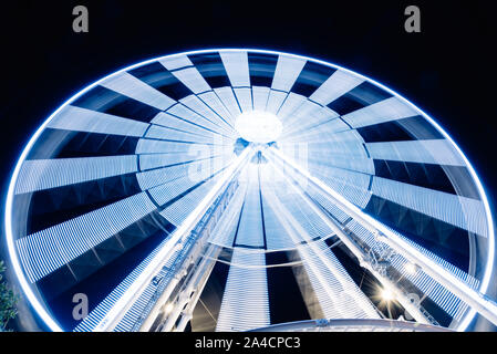 Ferris Wheel Spinning Long Exposure Neons Structure against Black Night at La Rochelle Stock Photo