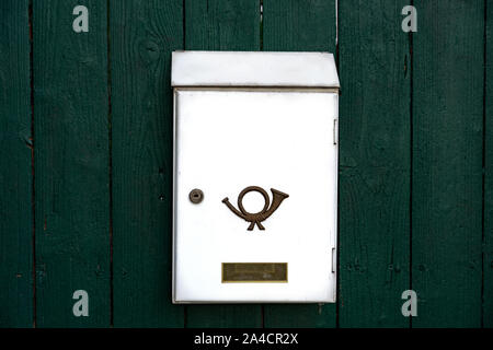 white empty mailbox on green wooden background Stock Photo