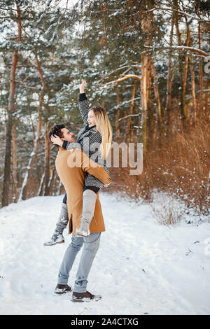 Happy couple in snow park Stock Photo - Alamy