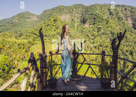 Young woman tourist on background of Tropical jungle of bali. Forest and mountain. Bali Travel Concept Stock Photo