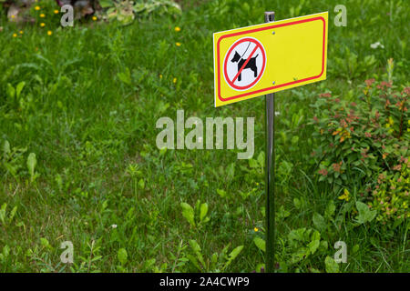 Yellow sign of animal walk prohibition on grass Stock Photo