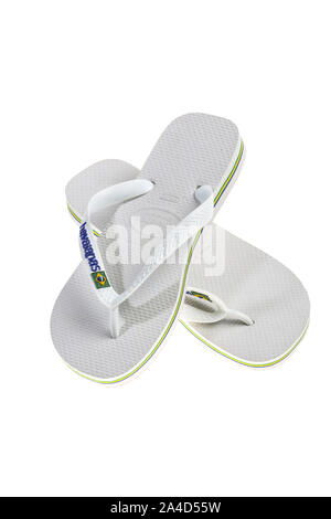 White flip-flops, bath sandals made of plastic with thong bridge and  diagonal strap fastening, brand Havaianas Stock Photo - Alamy
