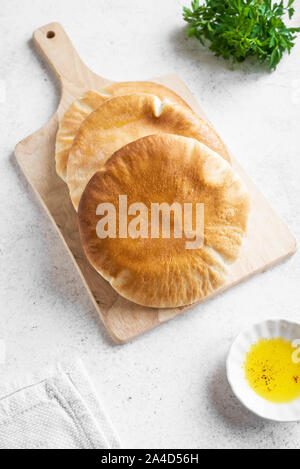 Indian Naan Flat Bread on white background, top view, copy space. Homemade Flatbread cooked in tandoor oven. Stock Photo
