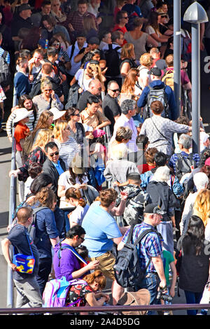 Aerial view crowd from above of tourist people standing on Westminster Pier waiting to board River Thames sightseeing tour boat London England UK Stock Photo