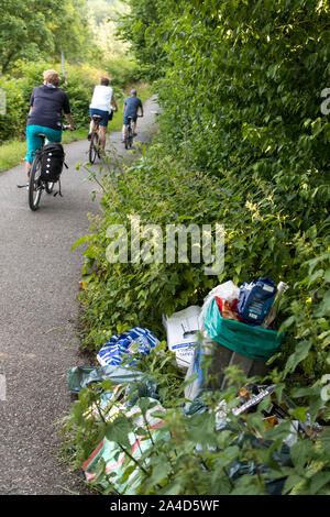Lot of garbage was deposited next to a trash can, on a walkway, barbecue waste, illegal, Stock Photo