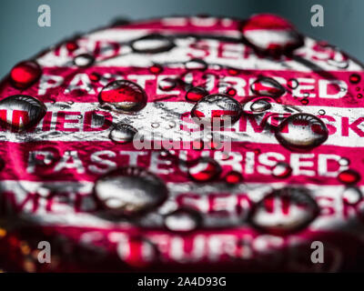 British Milk Bottle Top - Semi Skimmed Milk Bottle top wet from rain Stock Photo