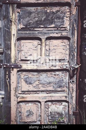 Old wooden door with peeling paint, color toning applied. Stock Photo