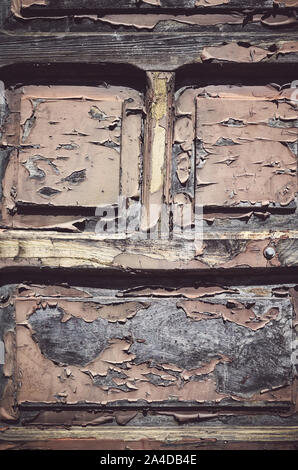 Old wooden door with peeling paint, color toning applied. Stock Photo