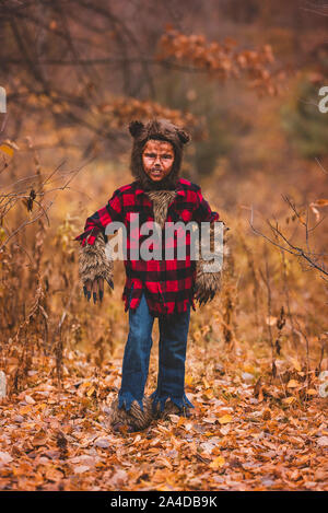 Portrait of a boy standing in forest dressed as a werewolf for Halloween, United States Stock Photo