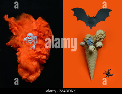 Halloween background with ice cream cone with dried flowers ,bats, spider and orange torch in the shape of a heart, skull on black-orange background.H Stock Photo