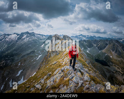 Woman hiking along ridge of a mountain, Austrian Alps, Bad Gastein, Salzburg, Austria Stock Photo