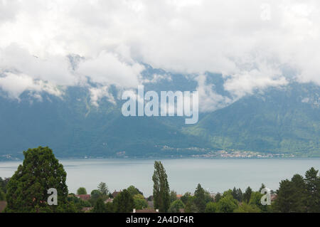 Dark Clouds Floating Over the Mountains besides Lake Geneva Stock Photo