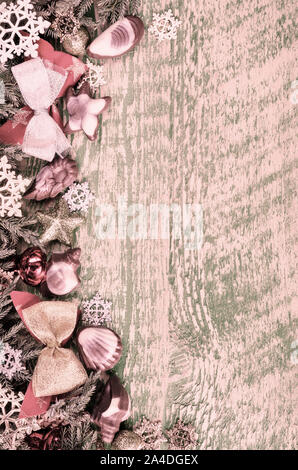 Tinted Christmas background, pink color. Wooden surface and Christmas decorations Stock Photo