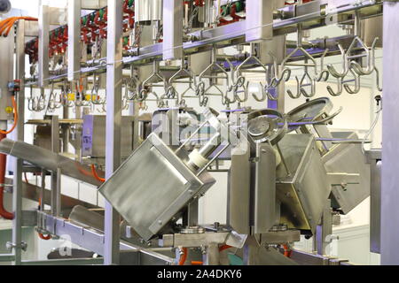 Complete set of the line of slaughter of a bird. Automated line for cutting and portioning poultry carcasses. Equipment in the carcass cutting shop. P Stock Photo