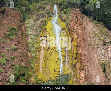 Close up of the wonderful El Limon tropical waterfall with lots of moss and steaming water, seen from below the waterfall in the Dominican Republic of Stock Photo