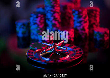 Casino theme.  Gambling games. Roulette, dice and poker chips on a colorful bokeh background. Stock Photo