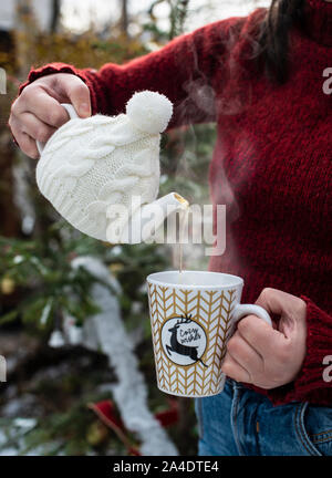 Premium Photo  A woman pours hot tea from a thermos.autumn mood.